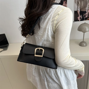 Chic black underarm bag with gold horseshoe buckle and chain strap for city commute