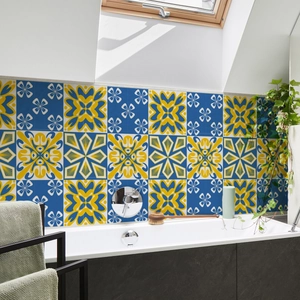 Close-up of blue and yellow floral geometric wall tiles in a modern bathroom setup