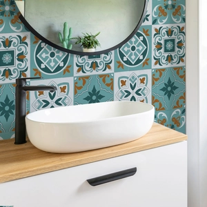 Close-up of bohemian mosaic tile stickers with vintage blue and orange patterns on a wall