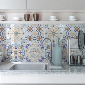 Detail of vintage French pattern wall stickers applied behind a kitchen sink