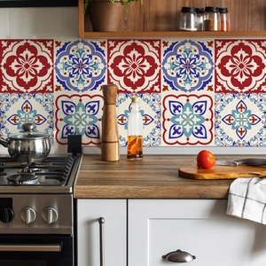 Detail of bohemian mandala tile stickers with red and blue patterns on a kitchen backsplash