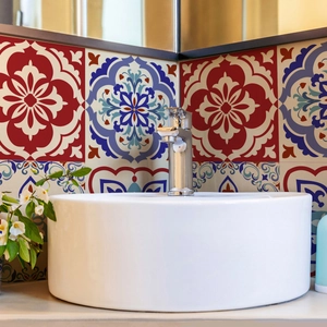 Moroccan style wall stickers with red and blue floral patterns on a bathroom wall