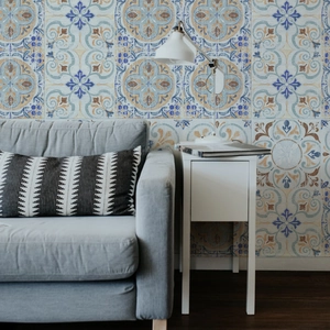 Moroccan style tile wallpaper featuring blue and orange mandala patterns on a sofa wall
