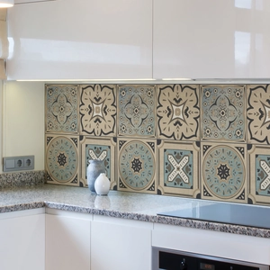 Close-up of geometric mandala wall stickers in retro beige and blue on a kitchen backsplash