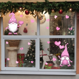 Detail of pink Valentine's gnome window decals with love hearts on glass surface