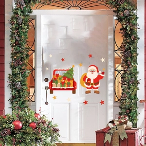 Detail of Christmas Santa and red truck static window decals on a festive door