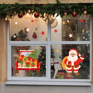 Detailed view of Christmas Santa gnome window decals on glass with a warm festive background
