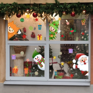 Christmas window stickers featuring Santa, snowman, and reindeer on glass pane with cozy decor