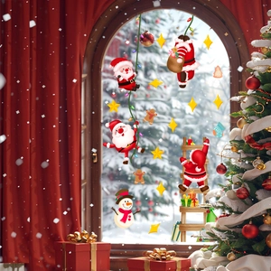 Detail of Christmas window clings featuring Santa, snowman, and stars on glass