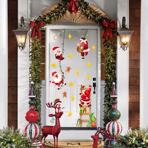 Christmas window decals with Santa, stars, and reindeer on a white front door background