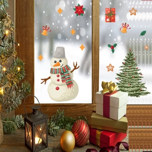 Detail view of festive snowman and Christmas tree static window clings on glass surface