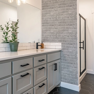 Detail of grey vintage faux marble wall tile with embossed texture in a bathroom