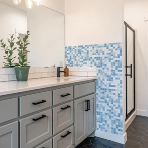 Close-up of blue mosaic wall tile stickers in a modern bathroom interior setting