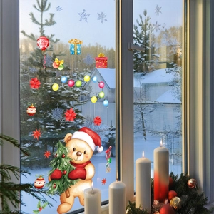 Detailed view of Christmas static window stickers with teddy bear and festive ornaments
