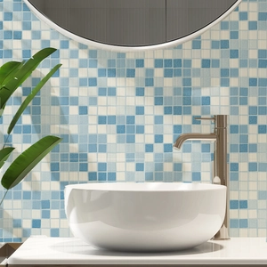 Blue and white mosaic tile backsplash with matte ceramic basin and brushed metal faucet