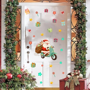 Detail of Christmas window stickers with Santa on a scooter and gifts on a white door