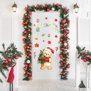 Christmas window decals with cute bears and festive bells on a white door display