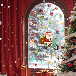 Christmas window stickers set featuring Santa on motorcycle and stars on a glass surface