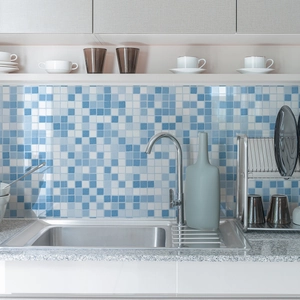 Blue and white mosaic tile backsplash applied on a modern kitchen wall behind a sink