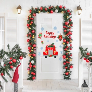 Detail of happy holidays window decal with red truck and snowflakes on white door