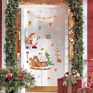 Creative Christmas gnome and Santa Claus static window stickers on a white door