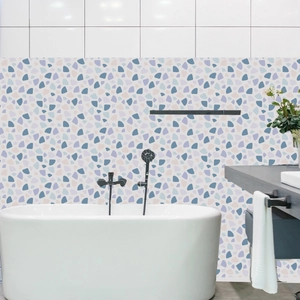 Close-up of waterproof terrazzo wall stickers with colorful patterns behind a bathtub