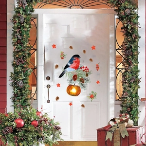 Detail of Christmas window stickers featuring a robin, pinecones, and festive red berries