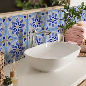 Blue and white marble texture wall sticker behind a bathroom sink with home decor