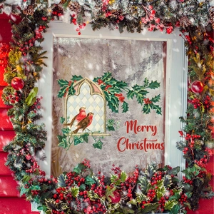 Close-up of a festive Christmas window cling with winter birds and holly berries