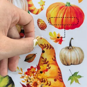 Close-up of double-sided autumn gnome window clings with pumpkins and maple leaves