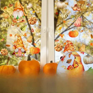 Detail of static fall window clings with gnomes and pumpkins on transparent glass