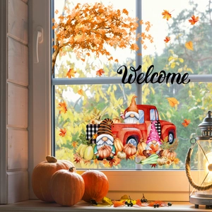 Close-up of autumn window decals featuring gnomes, maple leaves, and Welcome text