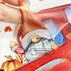 Close-up of double-sided autumn gnome window sticker showing transparency and colorful print