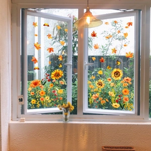 Detail of fall window clings featuring sunflower, maple leaves, and butterfly designs
