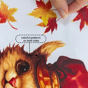 Macro detail of double-sided autumn squirrel and maple leaf window clings showing thickness