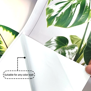 Close-up of self-adhesive backing on tropical leaf wall sticker for easy installation