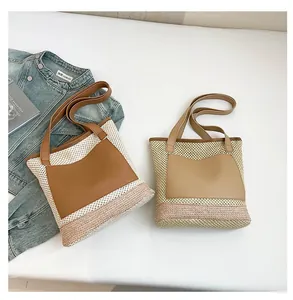 Detail of woven straw tote bags with leather pockets and handles for beach vacations