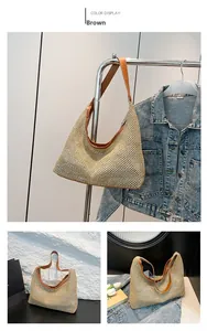 Detail of hollow woven straw beach bag with brown leather trim and sturdy handle