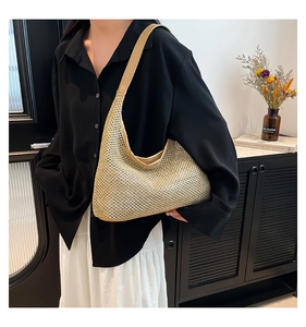 Detail of champagne gold woven beach bag with premium leather shoulder strap