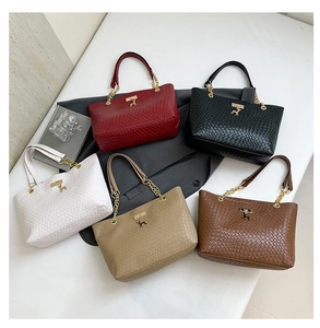 Close-up of woven texture shoulder bags in five colors with metal chain handles
