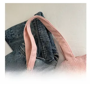 Close-up of comfortable corduroy handle on a pink tote bag with soft texture detail