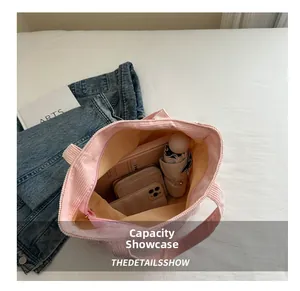 Pink corduroy tote bag showing large capacity with daily essentials inside
