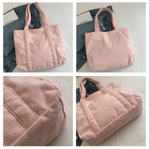 Macro view of pink corduroy tote bag showing fine ribbed texture and detailed stitching