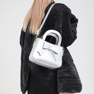 Chic metallic silver bow square handbag with adjustable strap for stylish shoulder wear