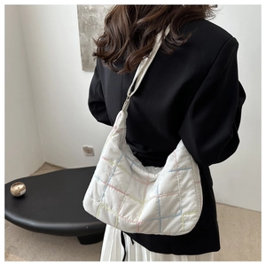 Detail of white quilted tote bag with colorful stitching and large capacity for casual use