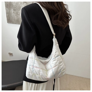 Detail of white quilted hobo bag featuring colorful grid stitching and soft nylon texture