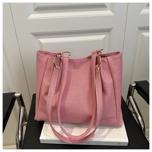 Detail of pink woven fabric tote bag with premium golden metal ring strap attachment