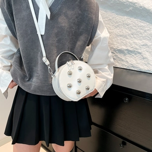 Modern white round chain crossbody bag with silver rivet details and adjustable strap