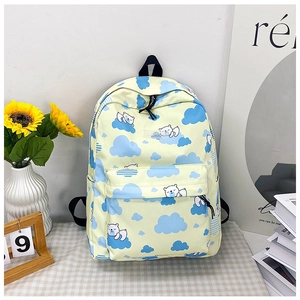 Détail du sac à dos en toile jaune avec motifs d'ours polaires et poche latérale à gourde