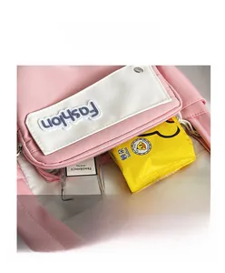 Detail of pink and white backpack front pocket showing daily essentials storage space